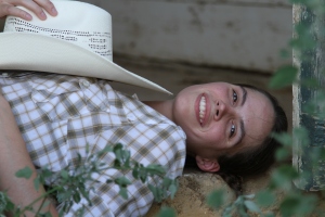 Bethany Peterson lays in the door of the stable where she boards her horses. (TCU/Bethany Peterson)