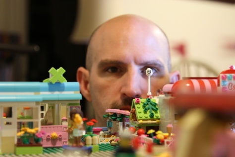 Carl Kurtz goofs off with the toy city he built for his daughter in their home in Fort Worth, TX on Sept. 29, 2013. (TCU/Bethany Peterson)